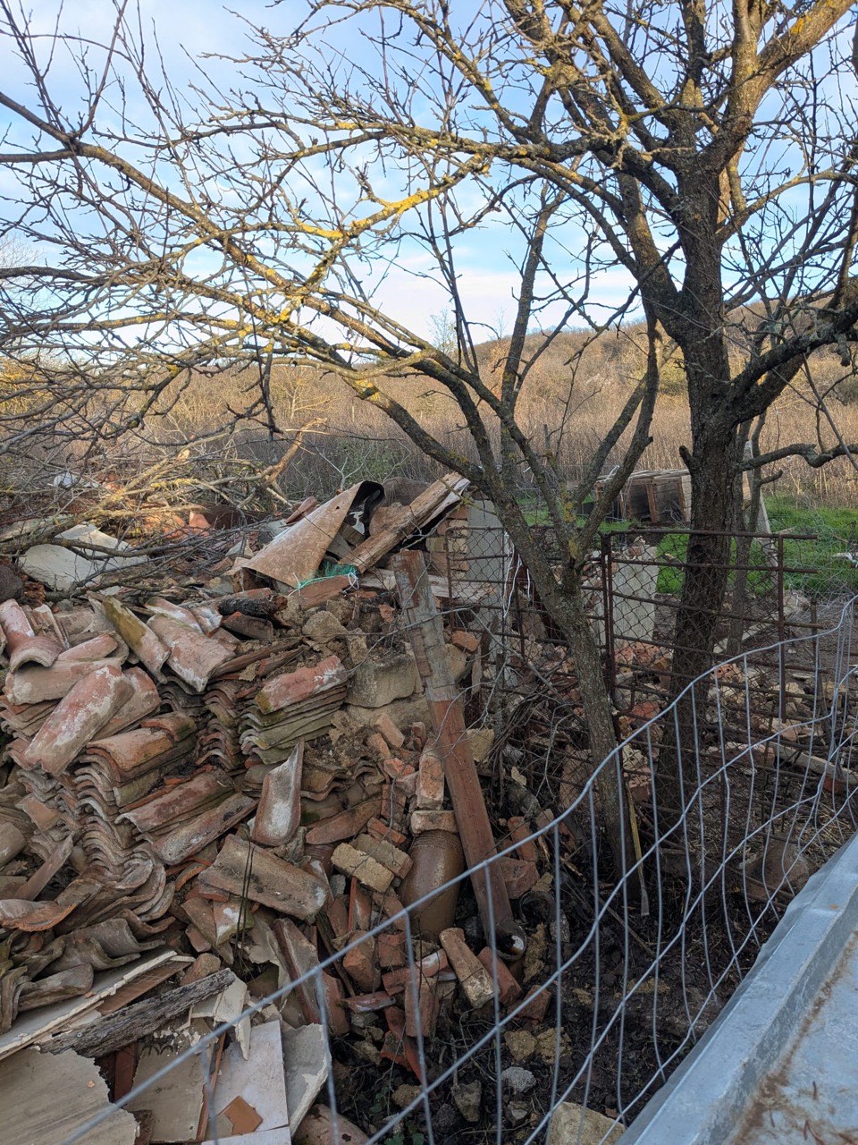 Close view of roof tiles and debris from old shed demolition