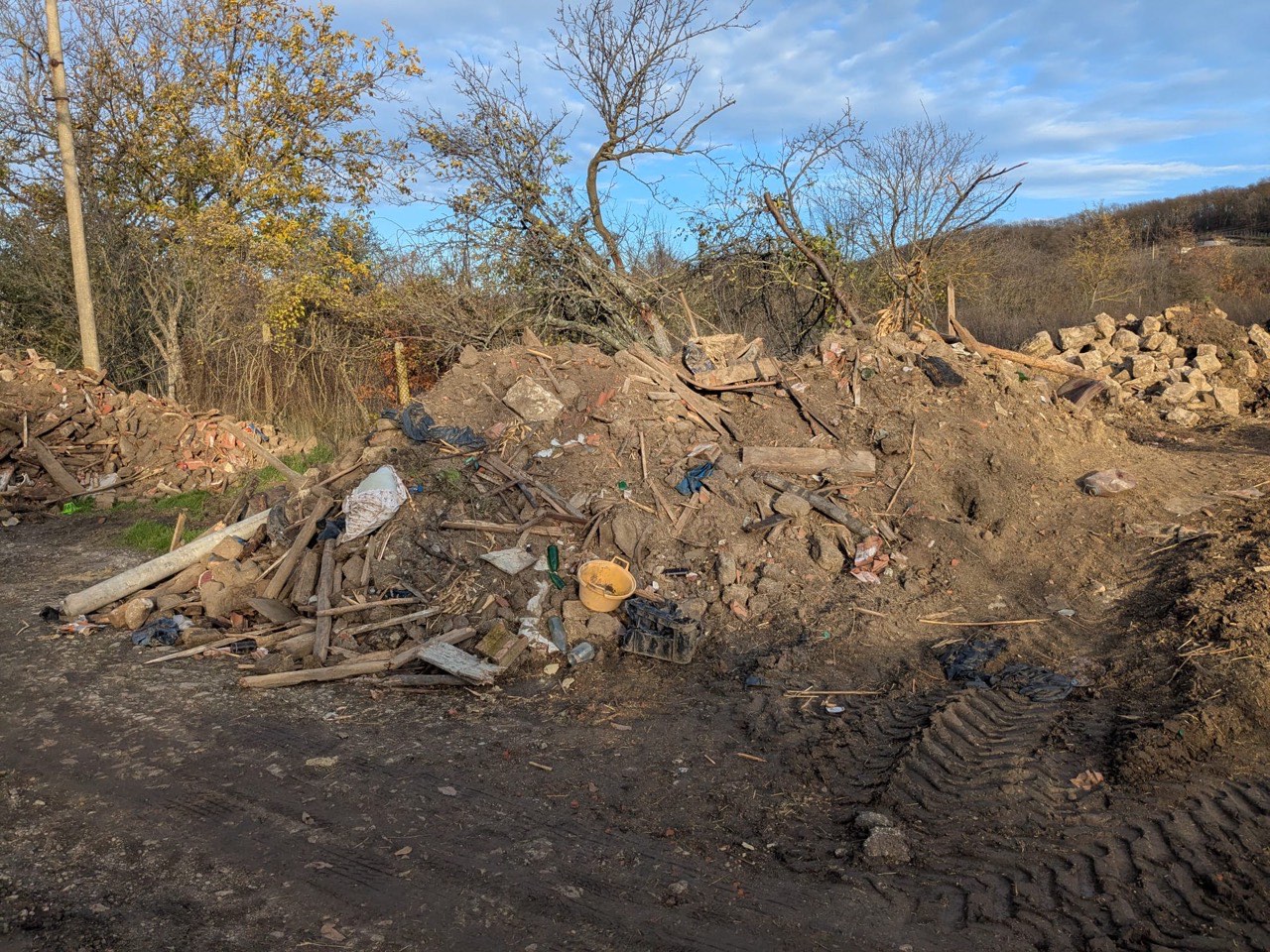 Earth and debris piles after old shed demolition at the Kiten KOIVU site