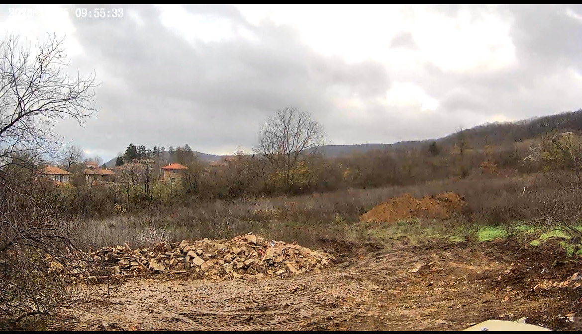 Cleared site area with soil piles after septic excavation